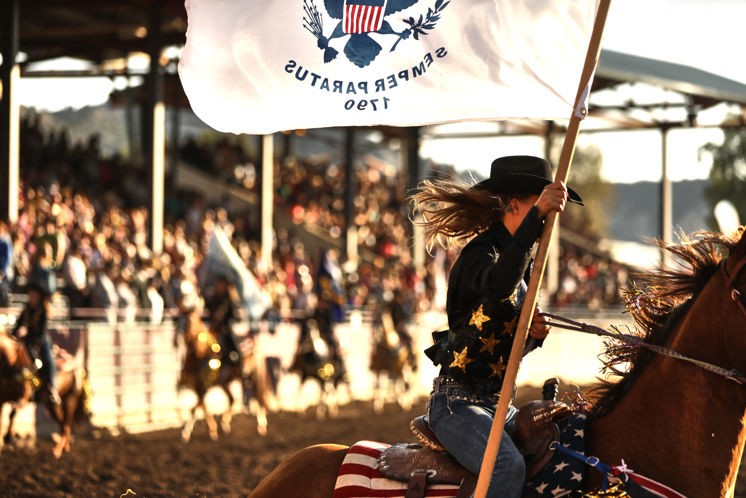 Eagle rodeo in eagle colorado girl riding with flag