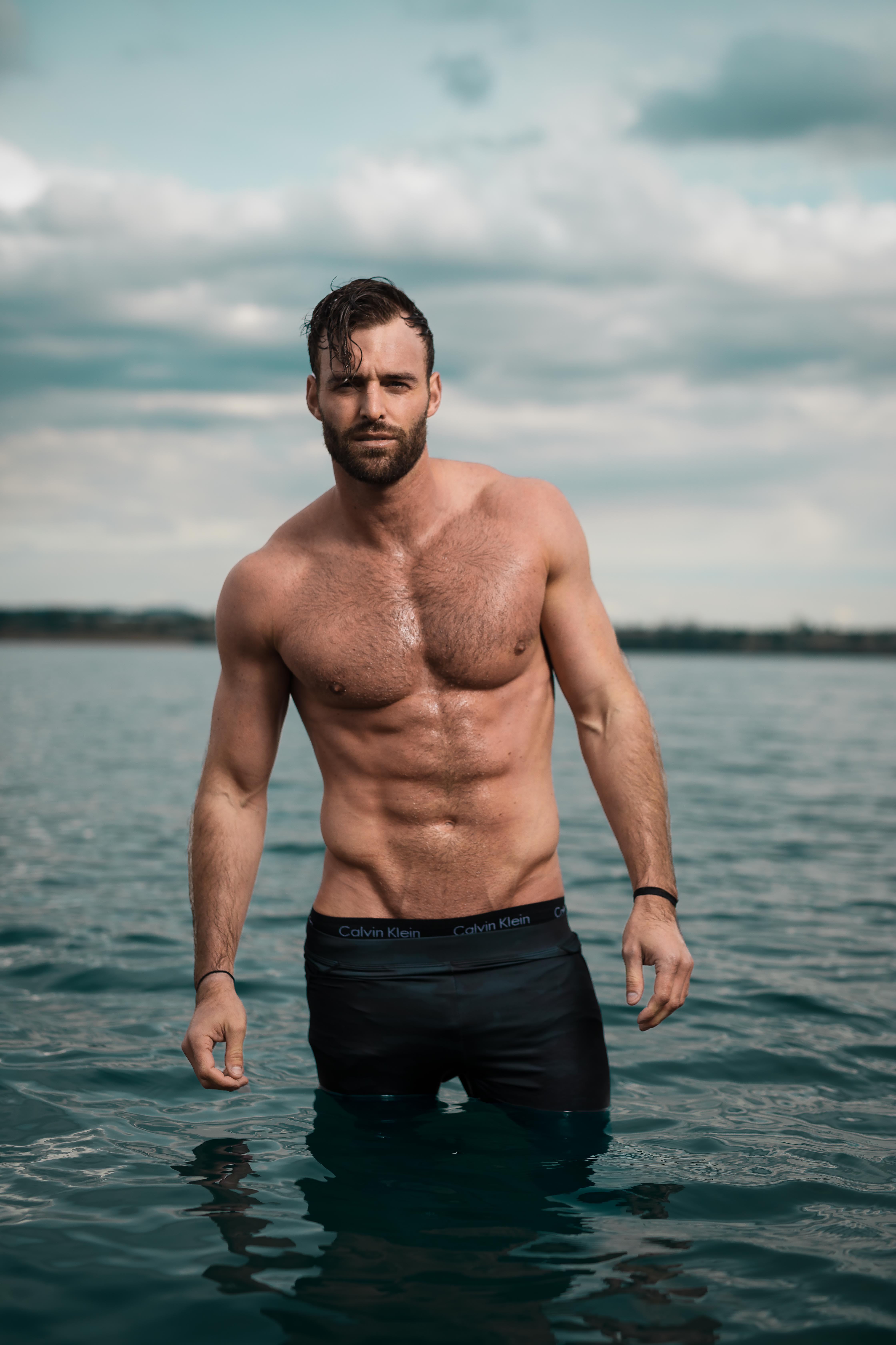 Robby Hayes standing in water shirtless